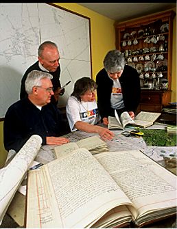Some of the group examining documents beneath a large scale map of Thriplow.  Photograph taken by David Ward and used with kind permission from the Countryside Commision.